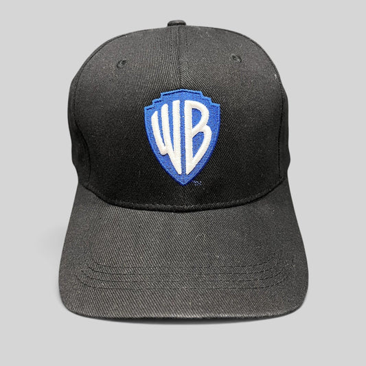 Raree Finds black fitted hat featuring an embroidered blue and silver Warner Bros WB shield logo on the front crown.