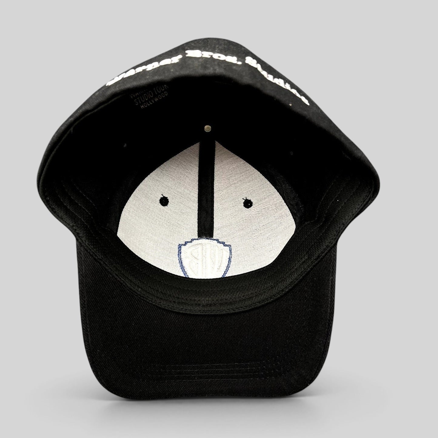 Raree Finds black fitted hat with Warner Bros Studio Tour Hollywood embroidery on the brim and interior WB logo
