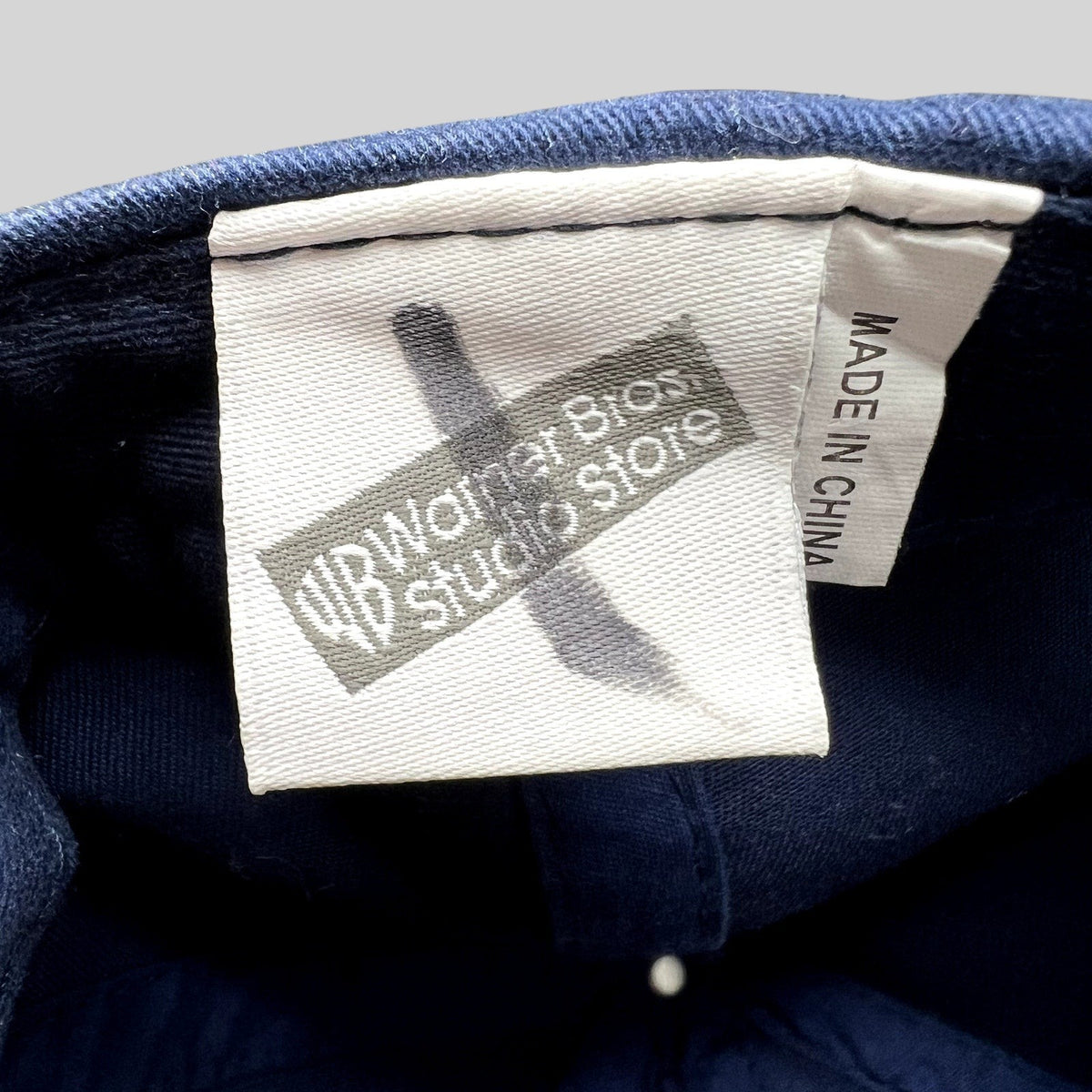 Raree Finds vintage Warner Bros Studio Store tag inside a navy blue Harry Potter Gryffindor Quidditch hat