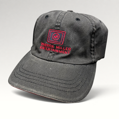 Raree Finds vintage black Warren Miller Entertainment Flexfit hat with red embroidered logo and brim piping
