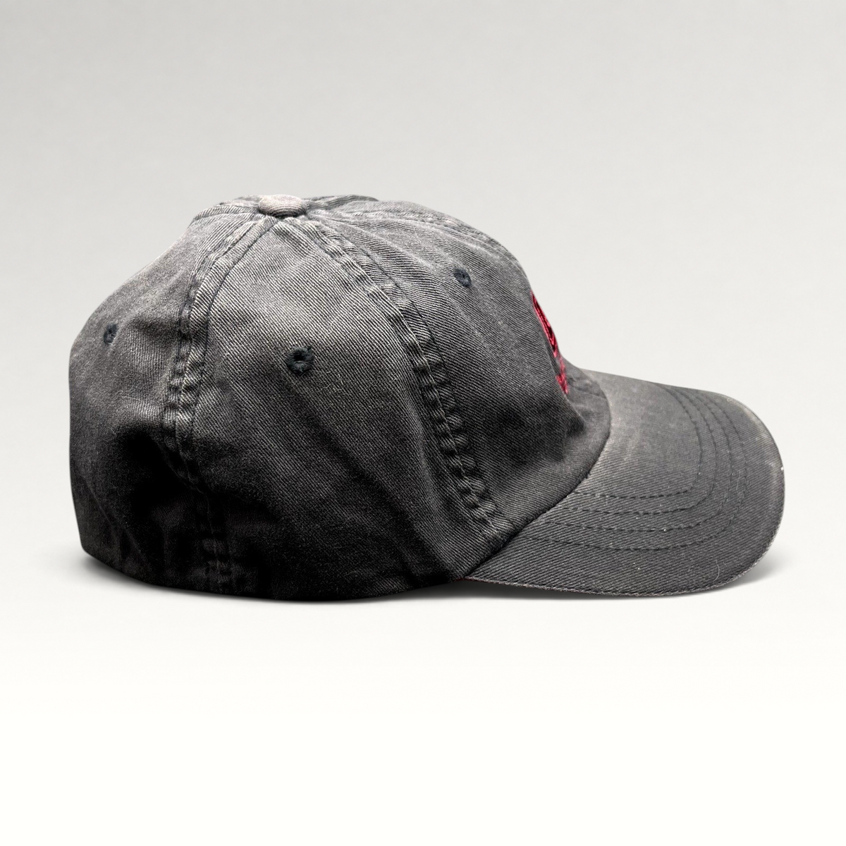 Raree Finds vintage Warren Miller Entertainment black Flexfit hat with red embroidered logo and brim piping