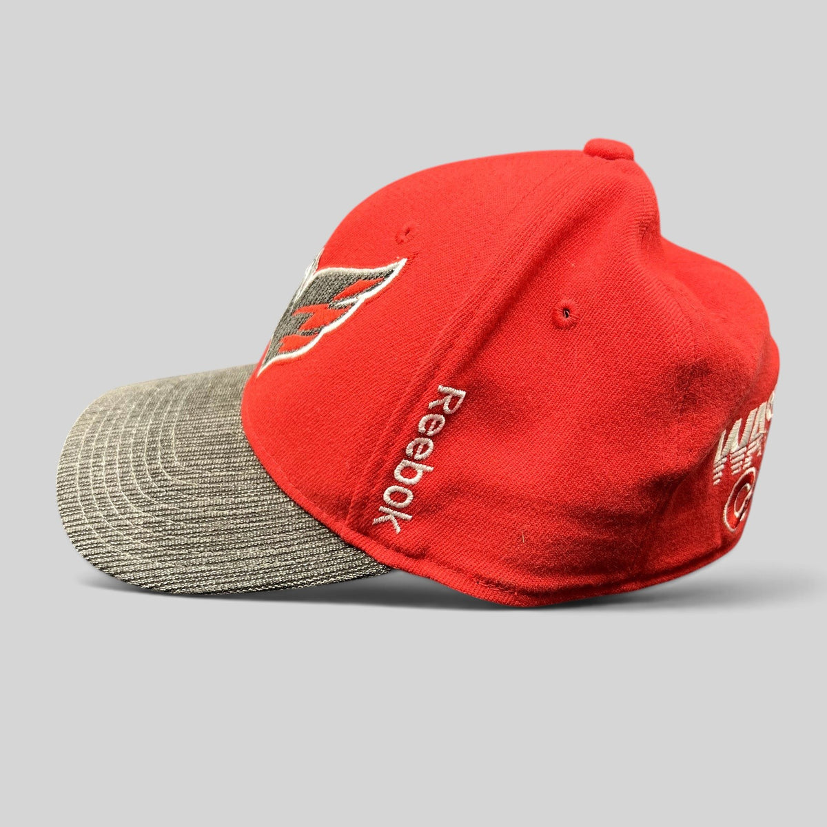 Raree Finds Washington Capitals Reebok Center Ice fitted hat in red with a textured gray brim and side logo embroidery.