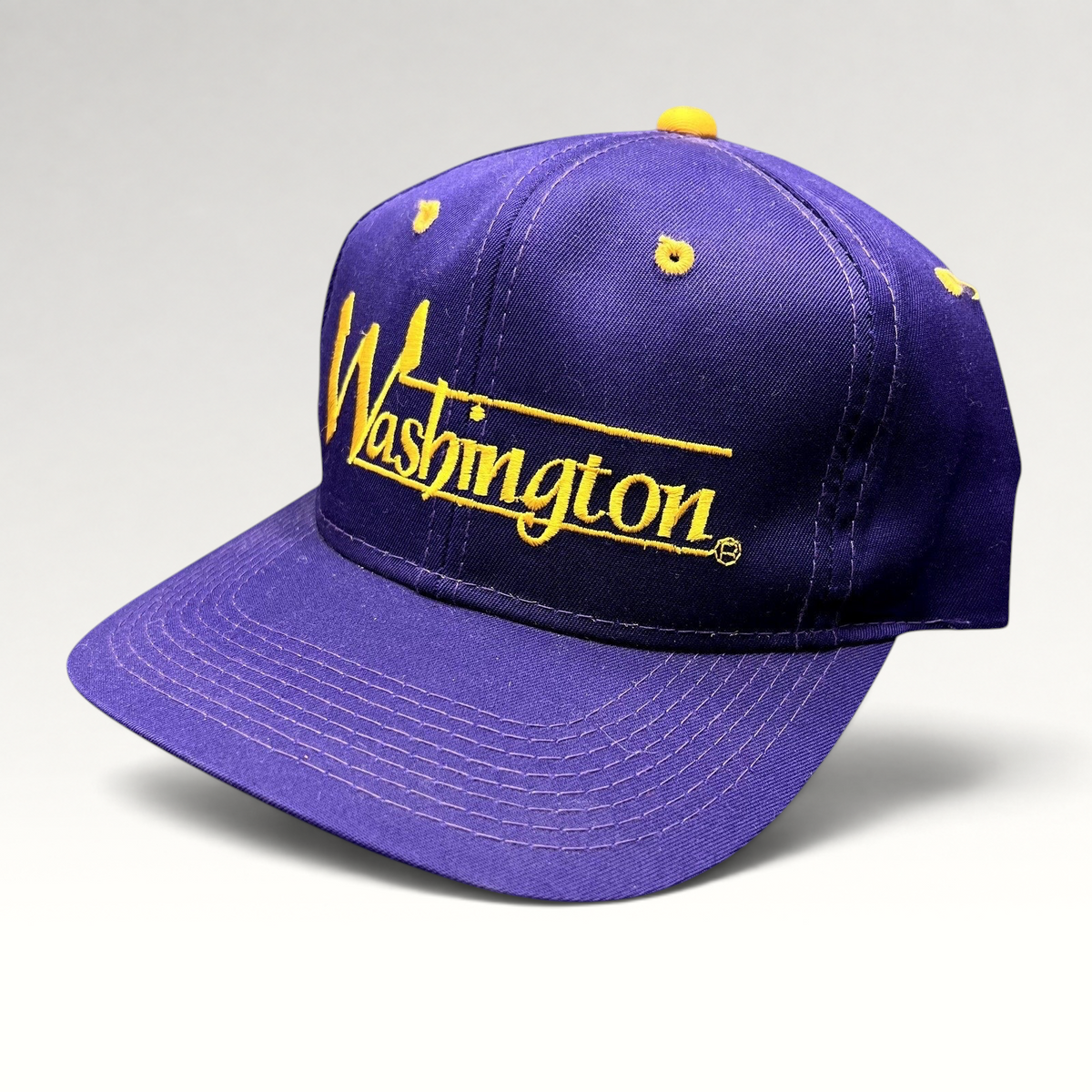 Raree Finds vintage Washington Huskies snapback hat in purple with gold embroidered script and green undervisor.