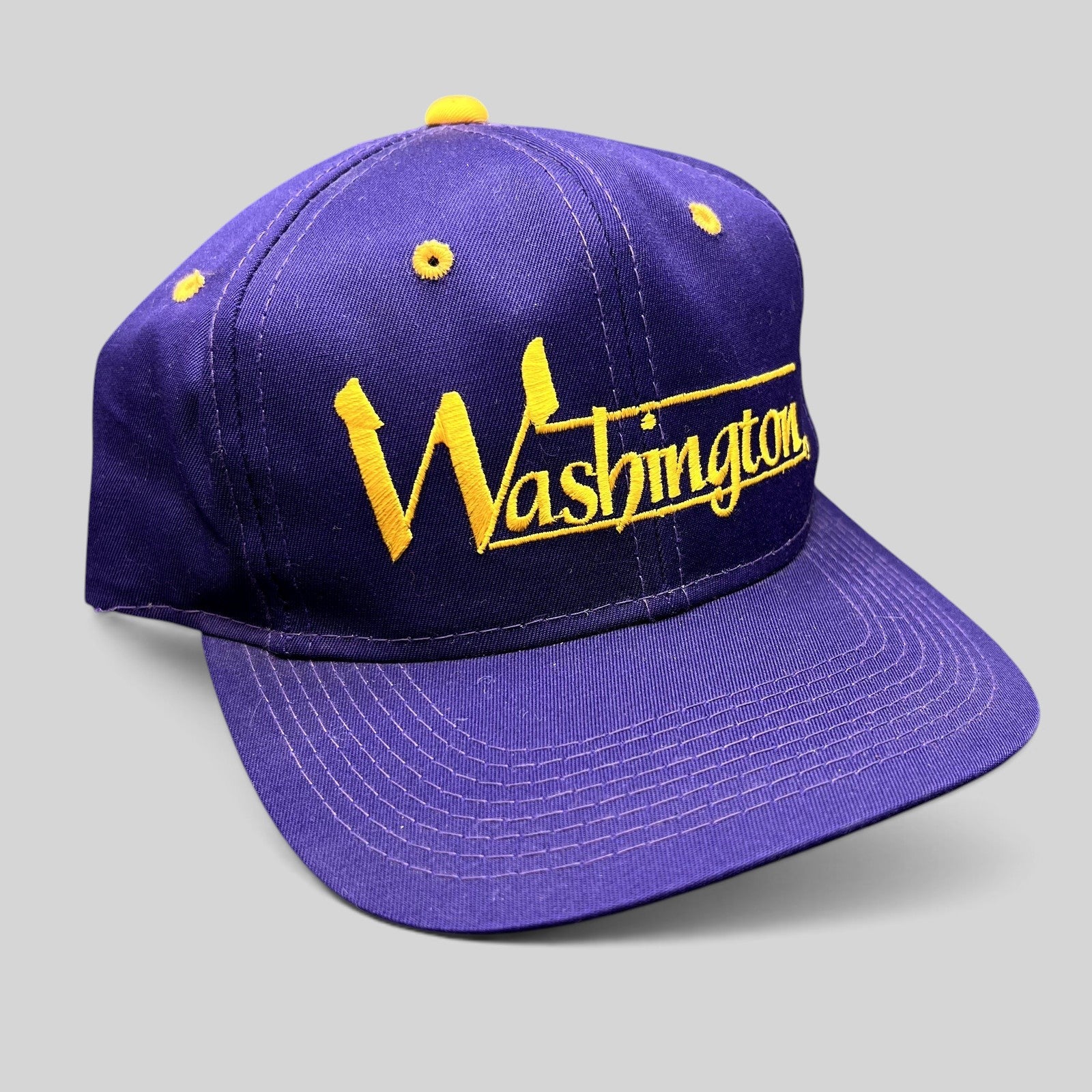 Raree Finds vintage Washington Huskies snapback hat in purple with gold embroidered script and structured crown.