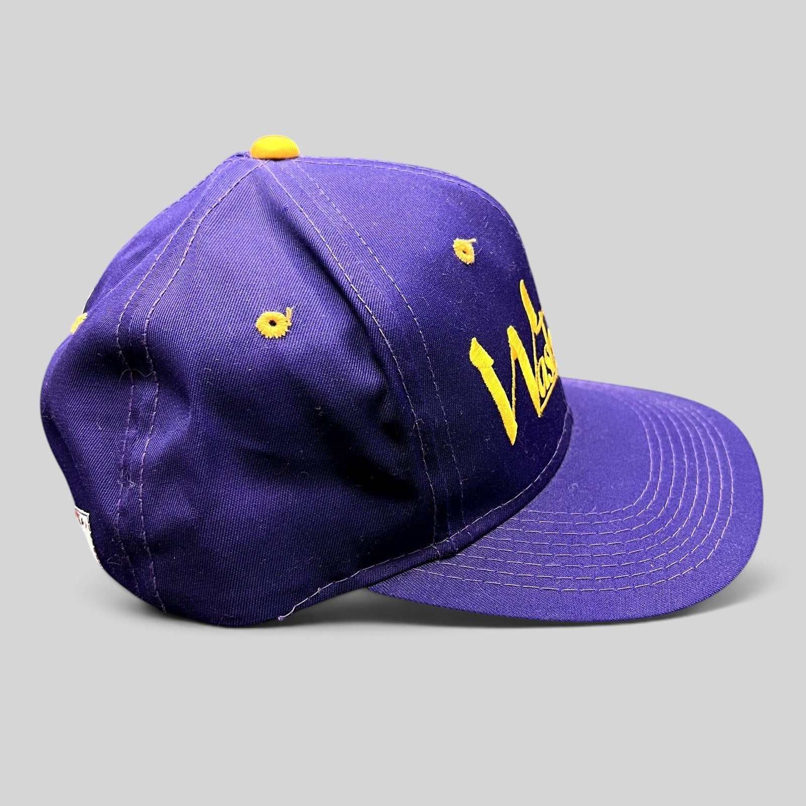 Raree Finds vintage Washington Huskies snapback hat in purple with gold embroidered script and structured crown.