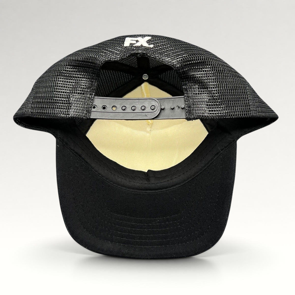 Raree Finds What We Do in the Shadows promo trucker hat back view with black mesh, snapback closure, and FX logo