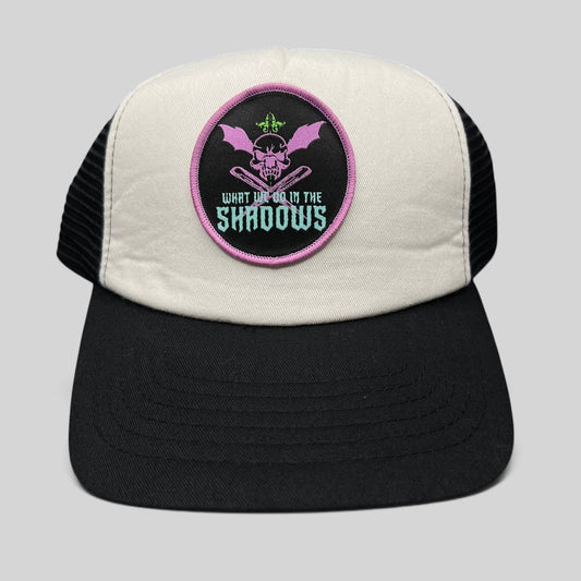 Raree Finds What We Do in the Shadows promo trucker hat with cream foam front, black mesh back, and gothic skull patch