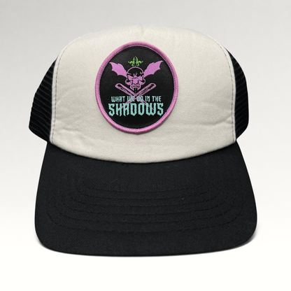 Raree Finds What We Do in the Shadows promo trucker hat with cream foam front, black mesh back, and gothic skull patch