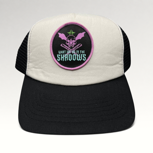 Raree Finds What We Do in the Shadows promo trucker hat with cream foam front, black mesh back, and gothic skull patch