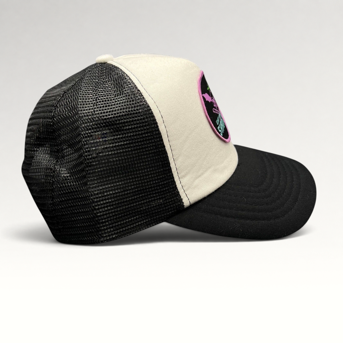 Raree Finds What We Do In The Shadows promo trucker hat in black and cream with gothic bat-winged skull patch