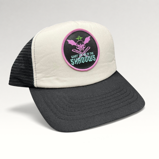 Raree Finds What We Do In The Shadows promo trucker hat with cream foam front, black mesh back, and gothic skull patch
