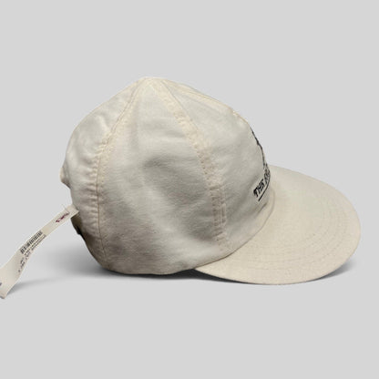 Raree Finds white cotton strapback golf hat featuring The Broadmoor resort logo, side view with tag attached.