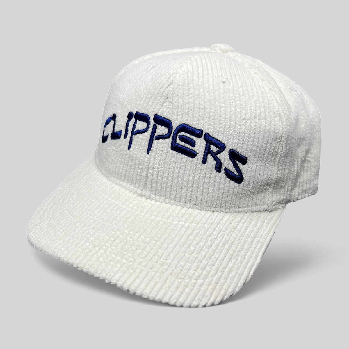 Raree Finds white corduroy Los Angeles Clippers strapback hat with royal blue embroidered wordmark on the front
