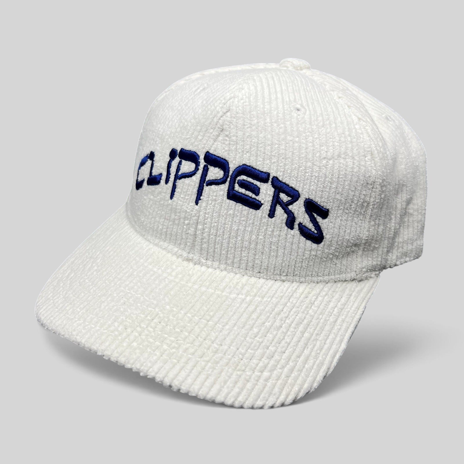Raree Finds white corduroy Los Angeles Clippers strapback hat with royal blue embroidered wordmark on the front