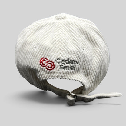 Raree Finds white corduroy Los Angeles Clippers strapback hat featuring an embroidered Cedars-Sinai logo on the back.