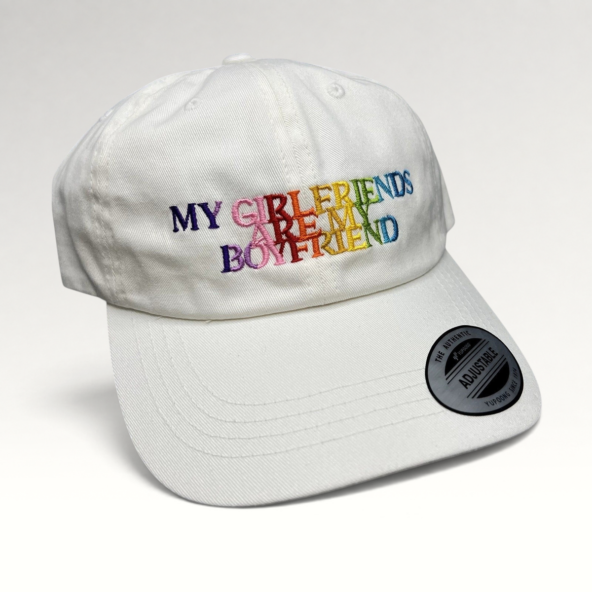 Raree Finds white cotton strapback hat with multicolor embroidered My Girlfriends Are My Boyfriend text and Yupoong tag