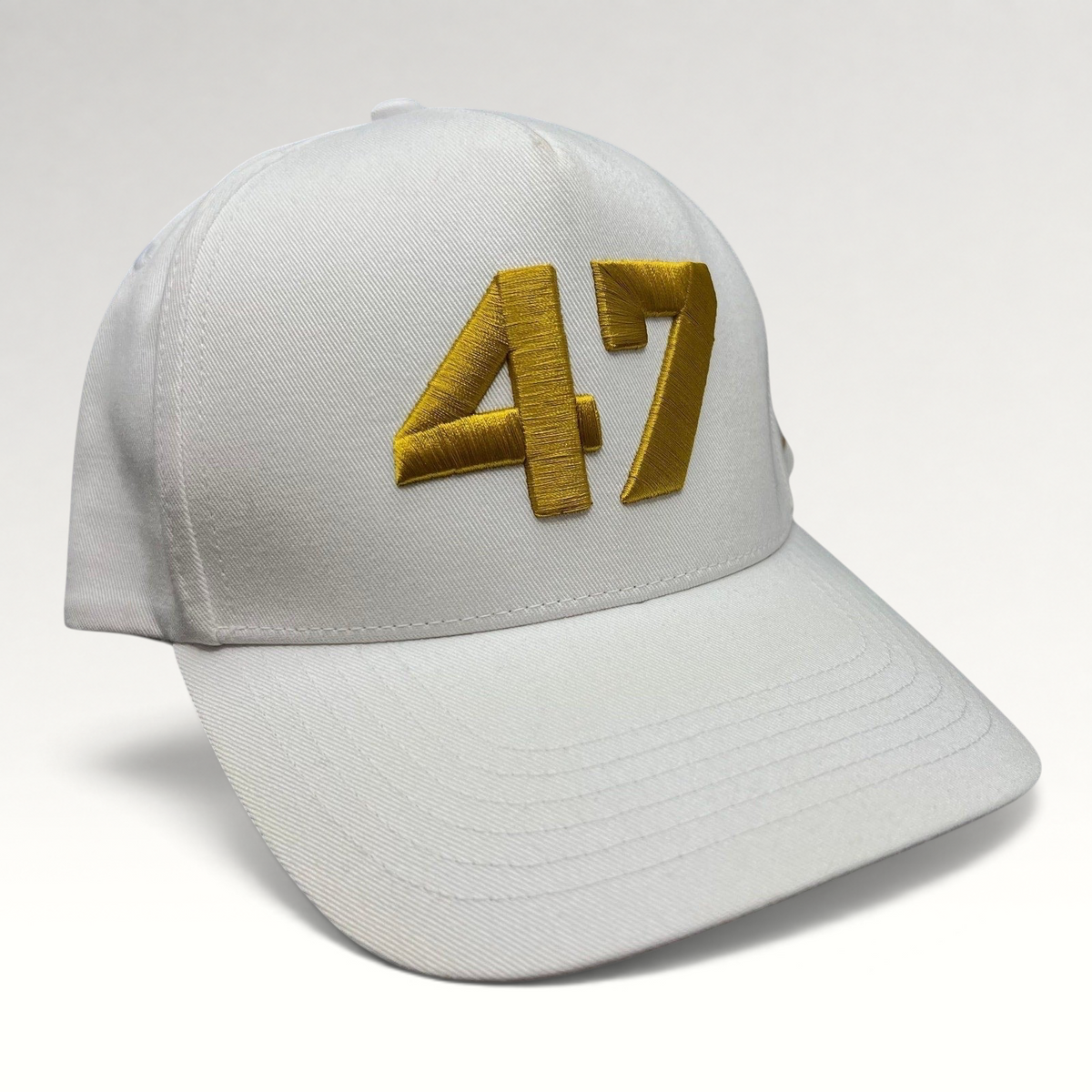 Raree Finds white cotton twill snapback hat with bold gold embroidered 47 on the front and a flat brim