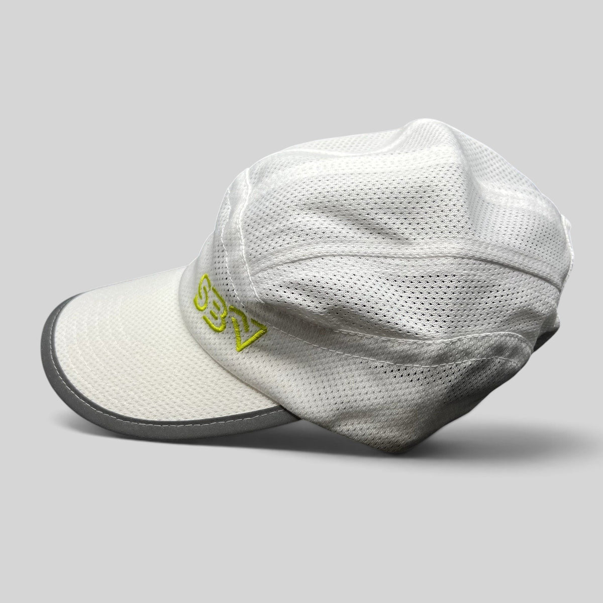 Raree Finds white 5-panel performance running hat with breathable mesh, reflective brim, and lime green SBV logo.