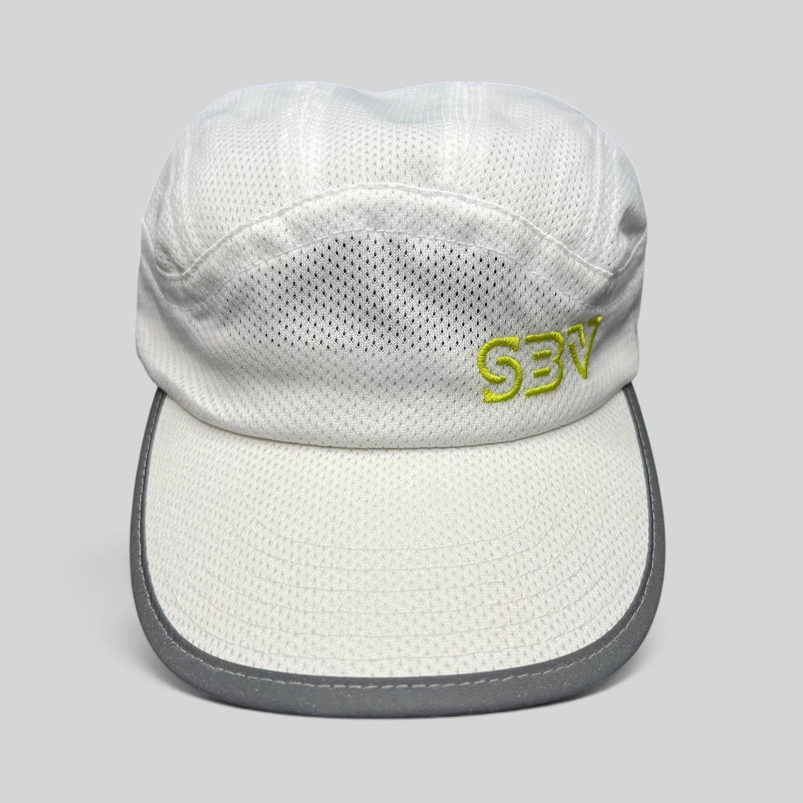 Raree Finds white 5-panel performance running cap with breathable mesh, reflective brim, and lime green SBV logo.