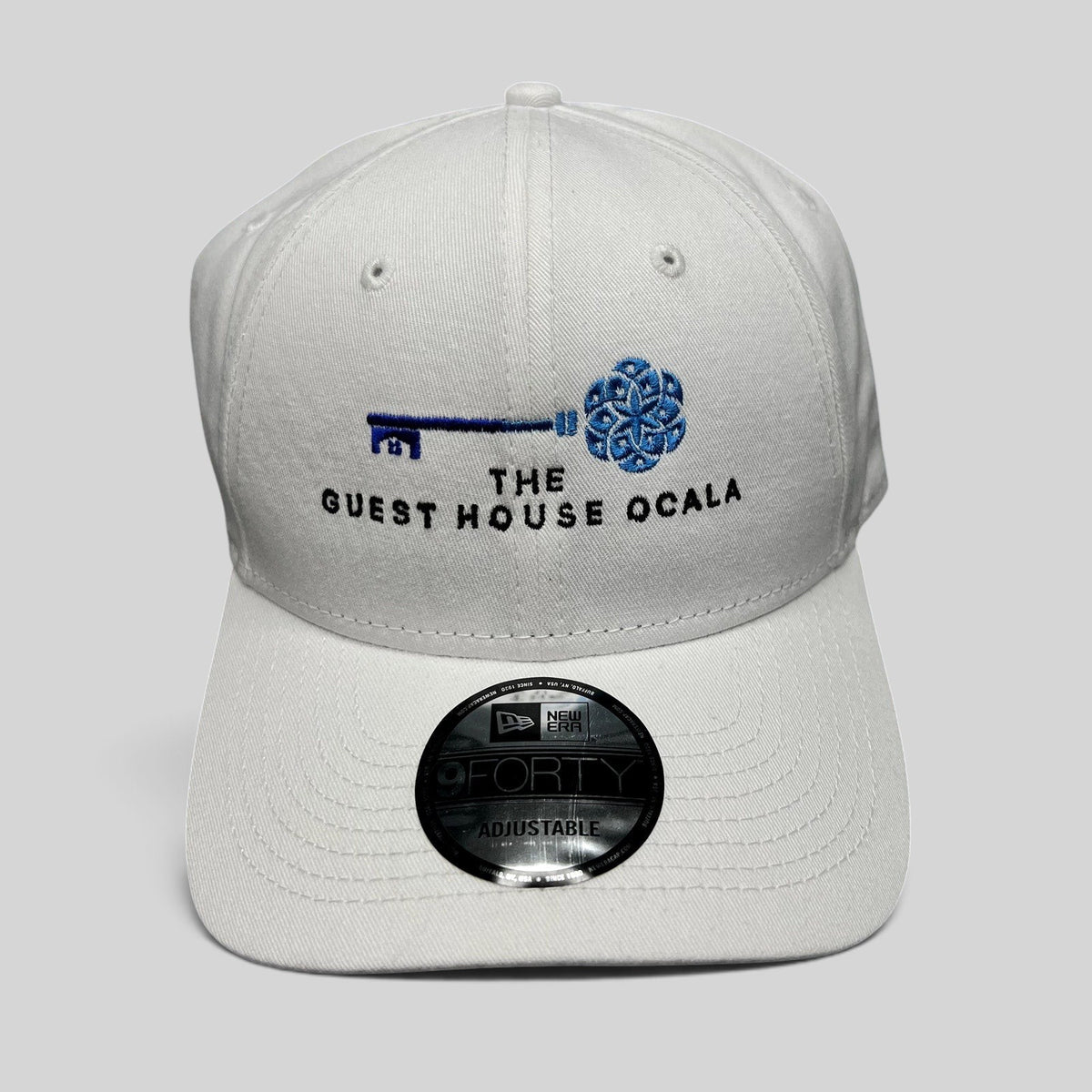 Raree Finds white New Era 9FORTY strapback hat with The Guest House Ocala blue key embroidery and curved brim