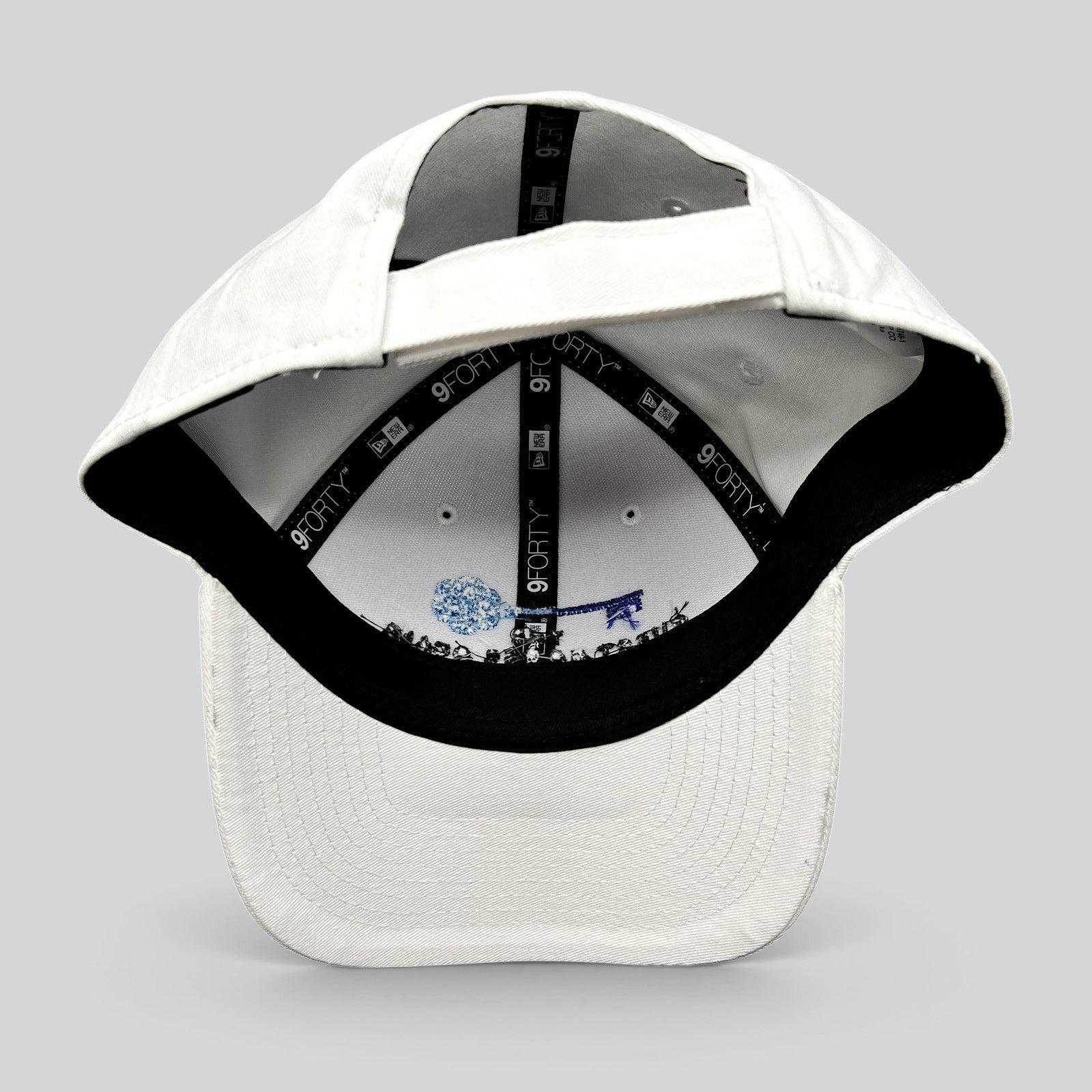 Raree Finds white New Era 9FORTY strapback hat interior view showing branded taping and embroidered key logo