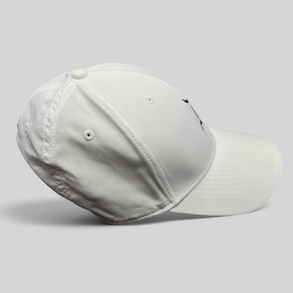 Raree Finds white Nike Legacy 91 Disney collaboration cap with embroidered D logo and structured performance fabric