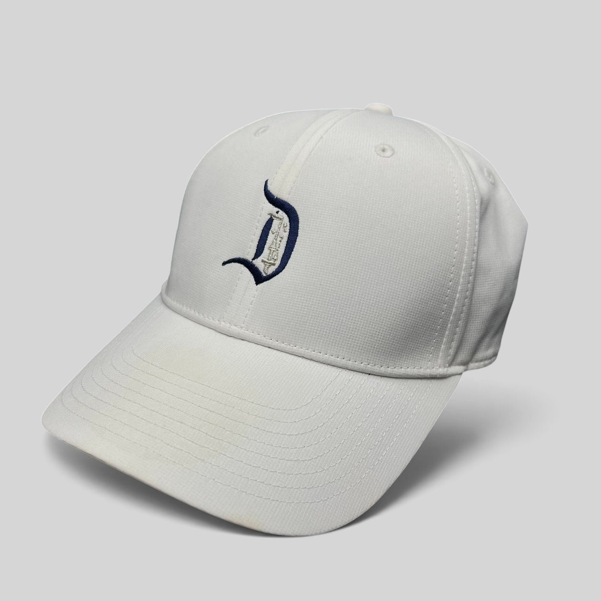 Raree Finds white Nike Legacy 91 Disney collaboration cap featuring an embroidered D logo on the front