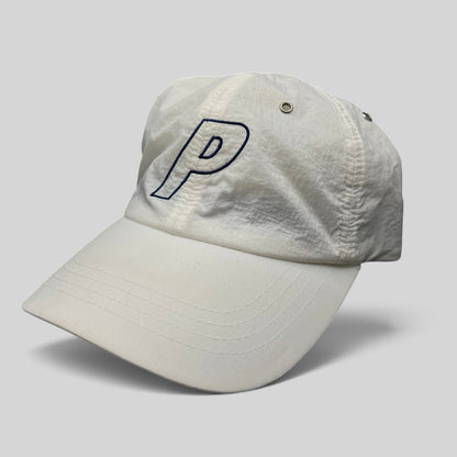 Raree Finds white Palace Skateboards strapback hat with an embroidered navy blue P logo on lightweight nylon fabric.
