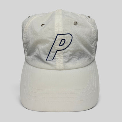 Raree Finds white Palace Skateboards strapback hat with an embroidered navy blue P logo on a lightweight nylon crown