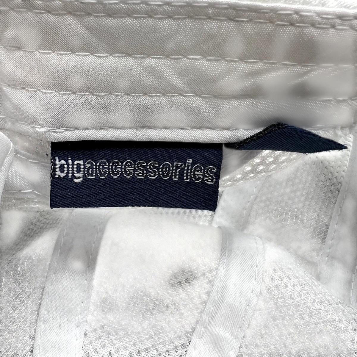 Raree Finds white performance cap interior label showing Big Accessories branding on a mesh technical hat