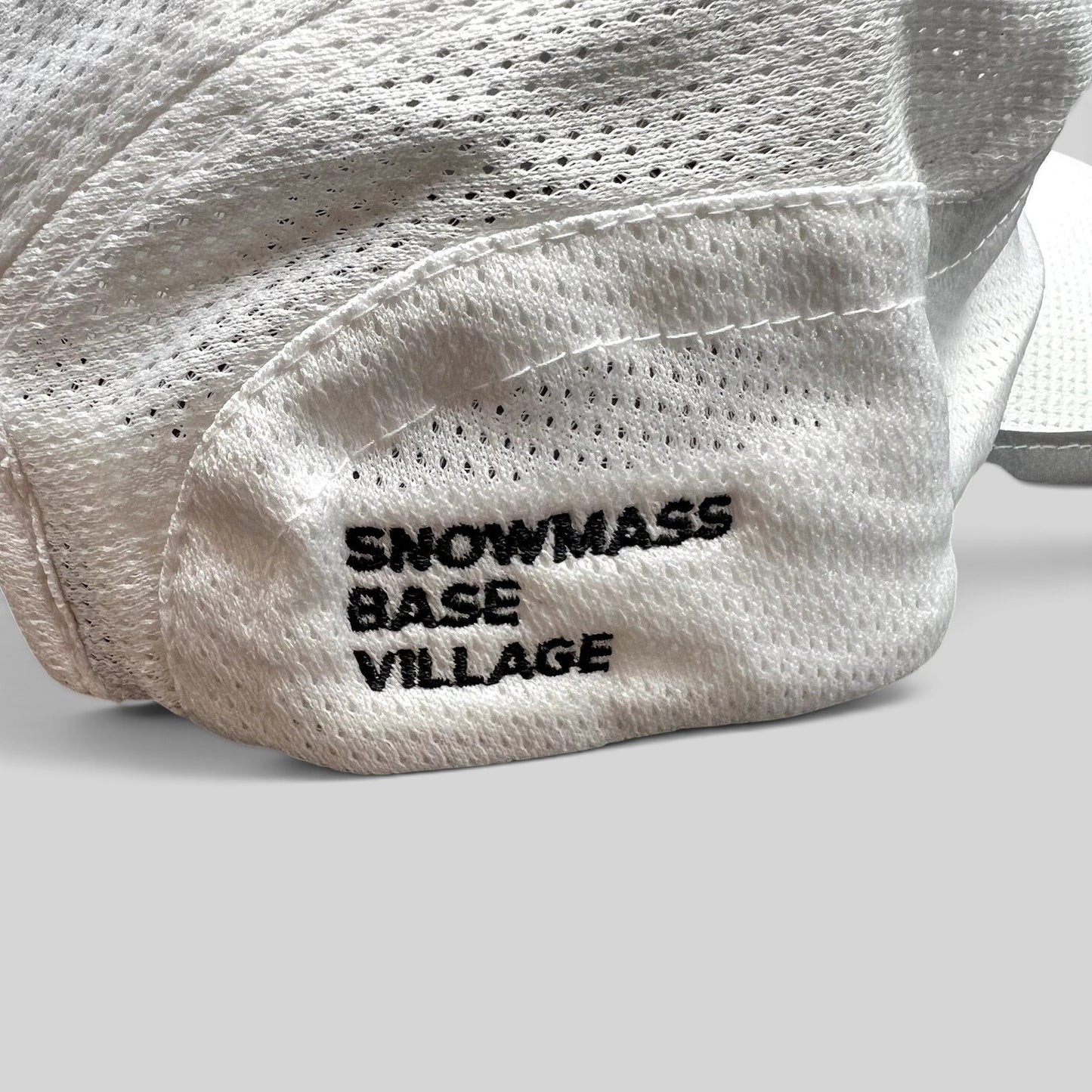 Raree Finds white performance running hat with Snowmass Base Village embroidery on breathable mesh fabric