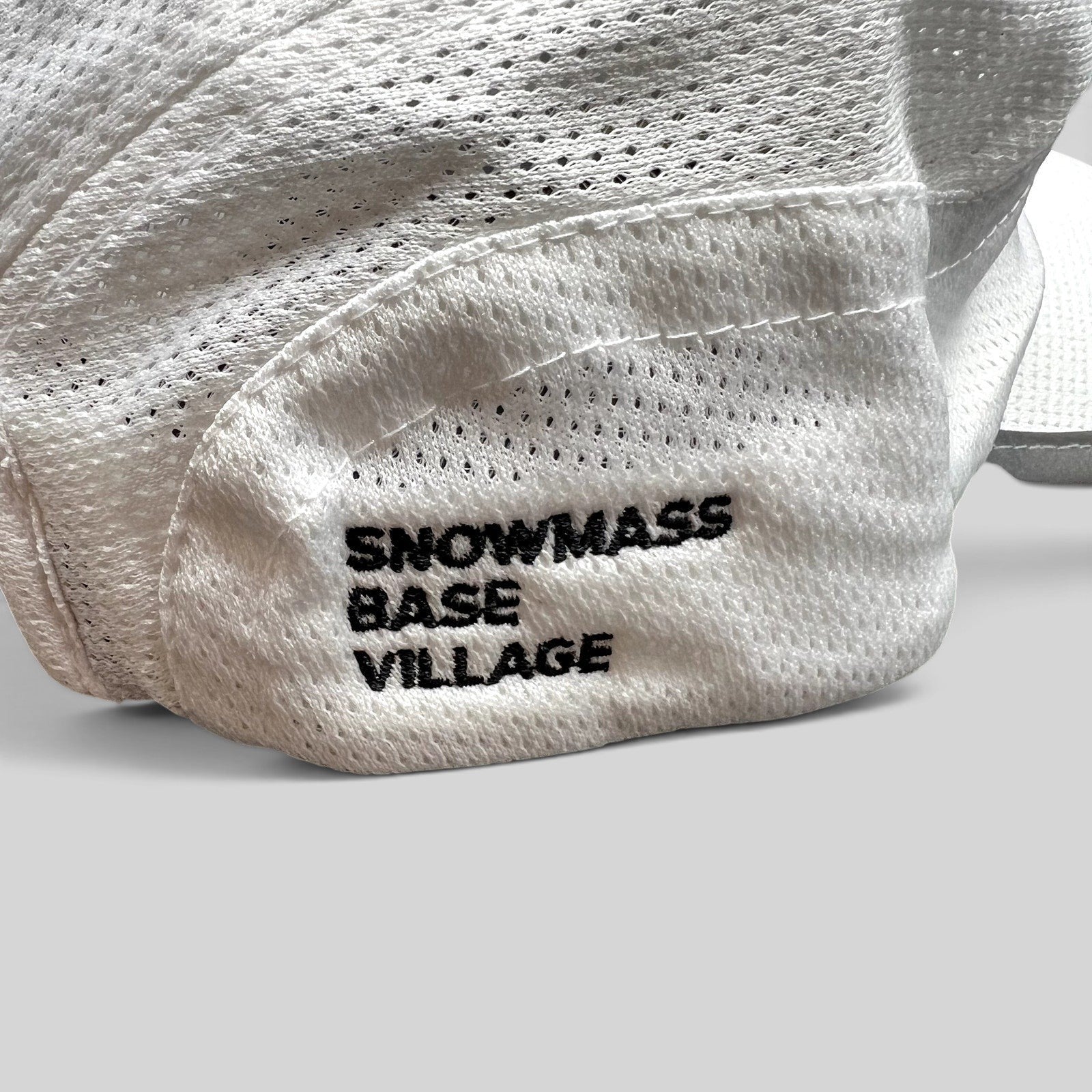 Raree Finds white performance running hat with Snowmass Base Village embroidery on breathable mesh fabric
