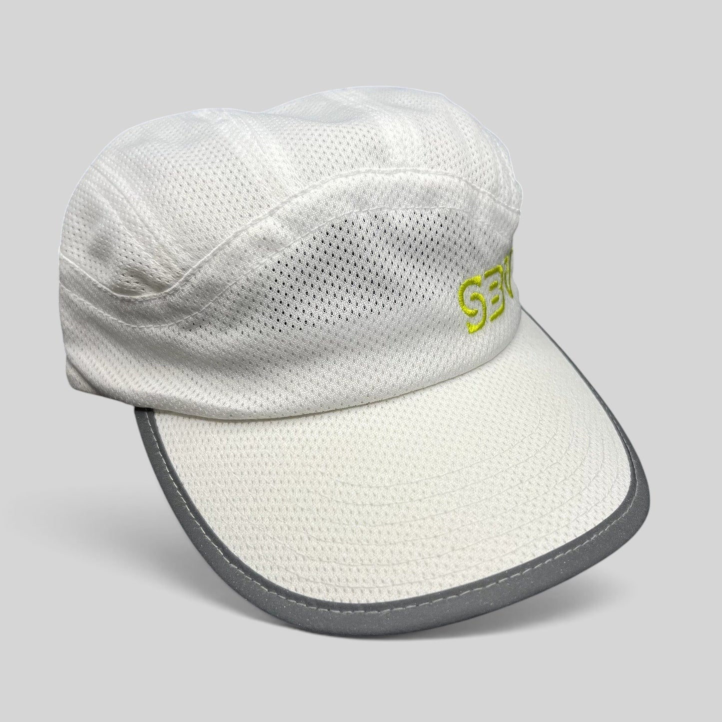 Raree Finds white 5-panel performance running hat with breathable mesh, reflective brim trim, and lime green SBV logo.