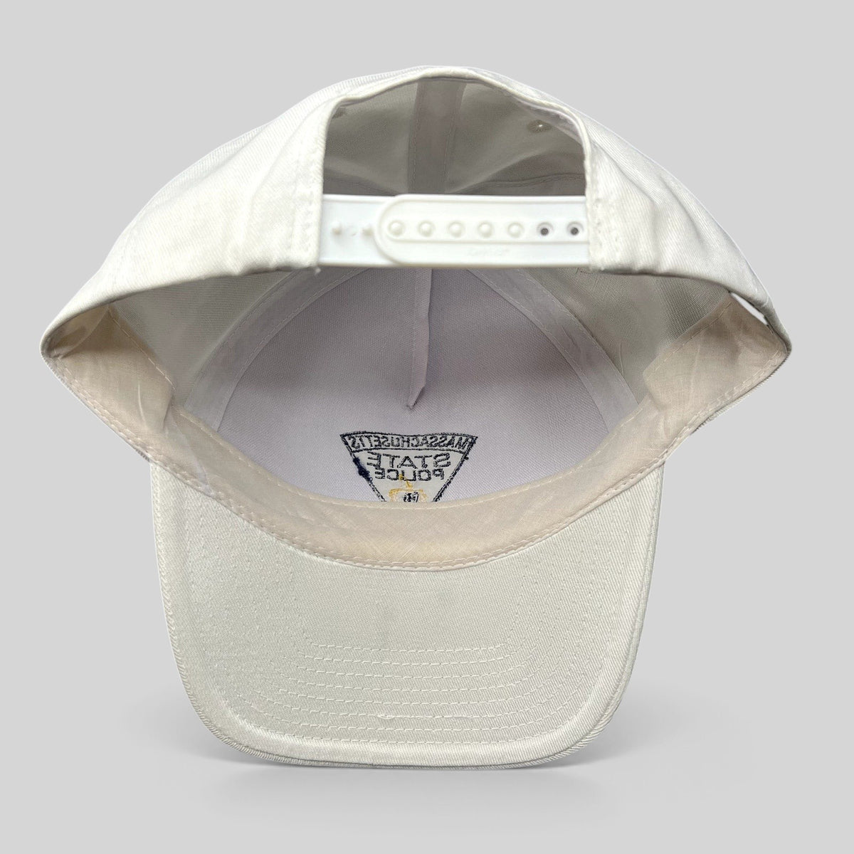 Raree Finds vintage white Massachusetts State Police snapback hat showing the interior adjustable plastic strap