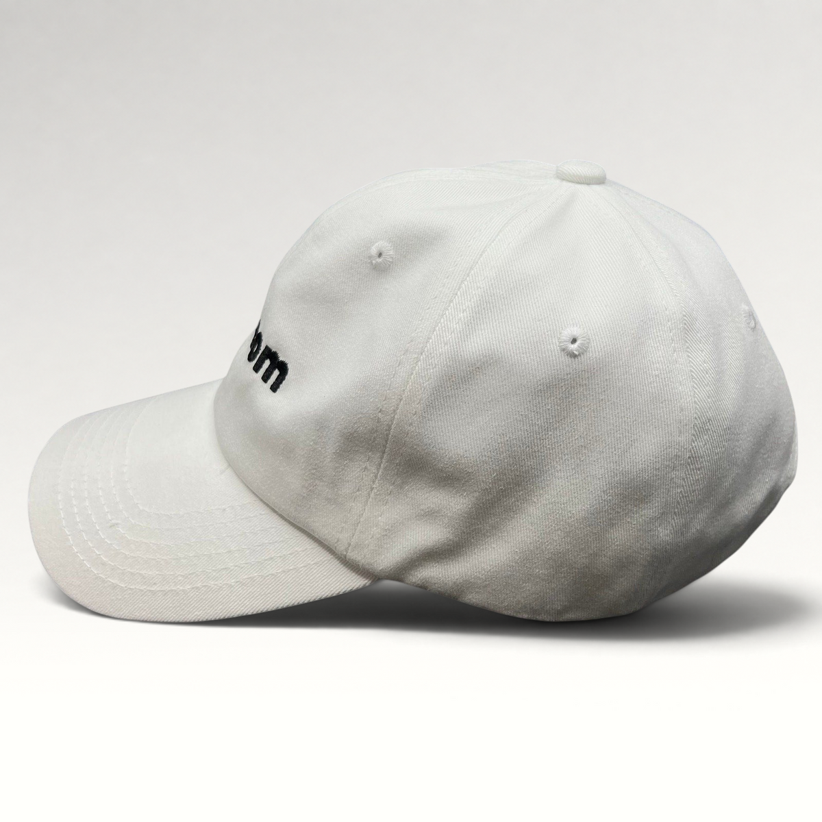 Raree Finds white cotton dad cap with black embroidered sex.com logo and side profile view