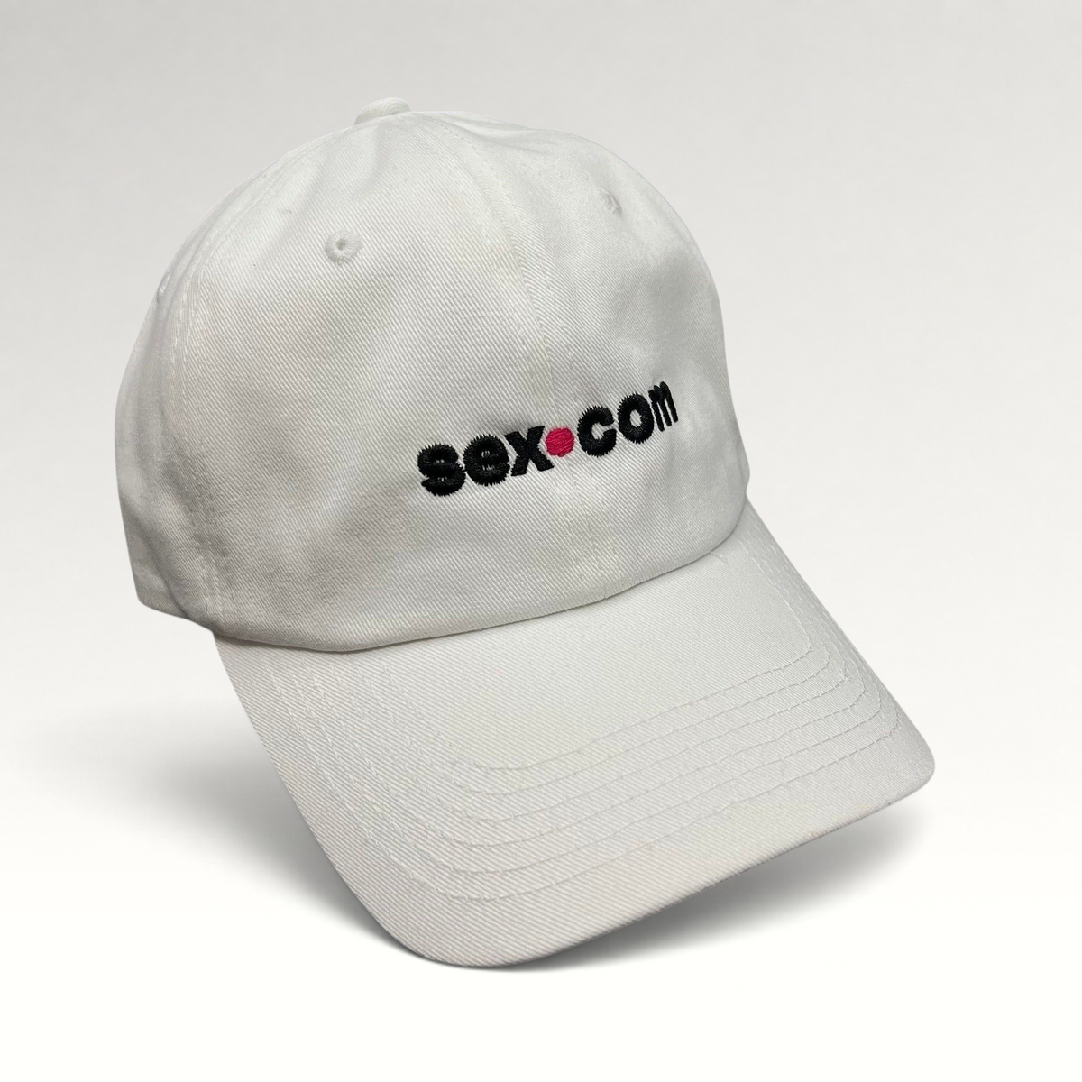 Raree Finds white cotton dad cap featuring an embroidered sex.com logo with a red dot accent and brass strapback