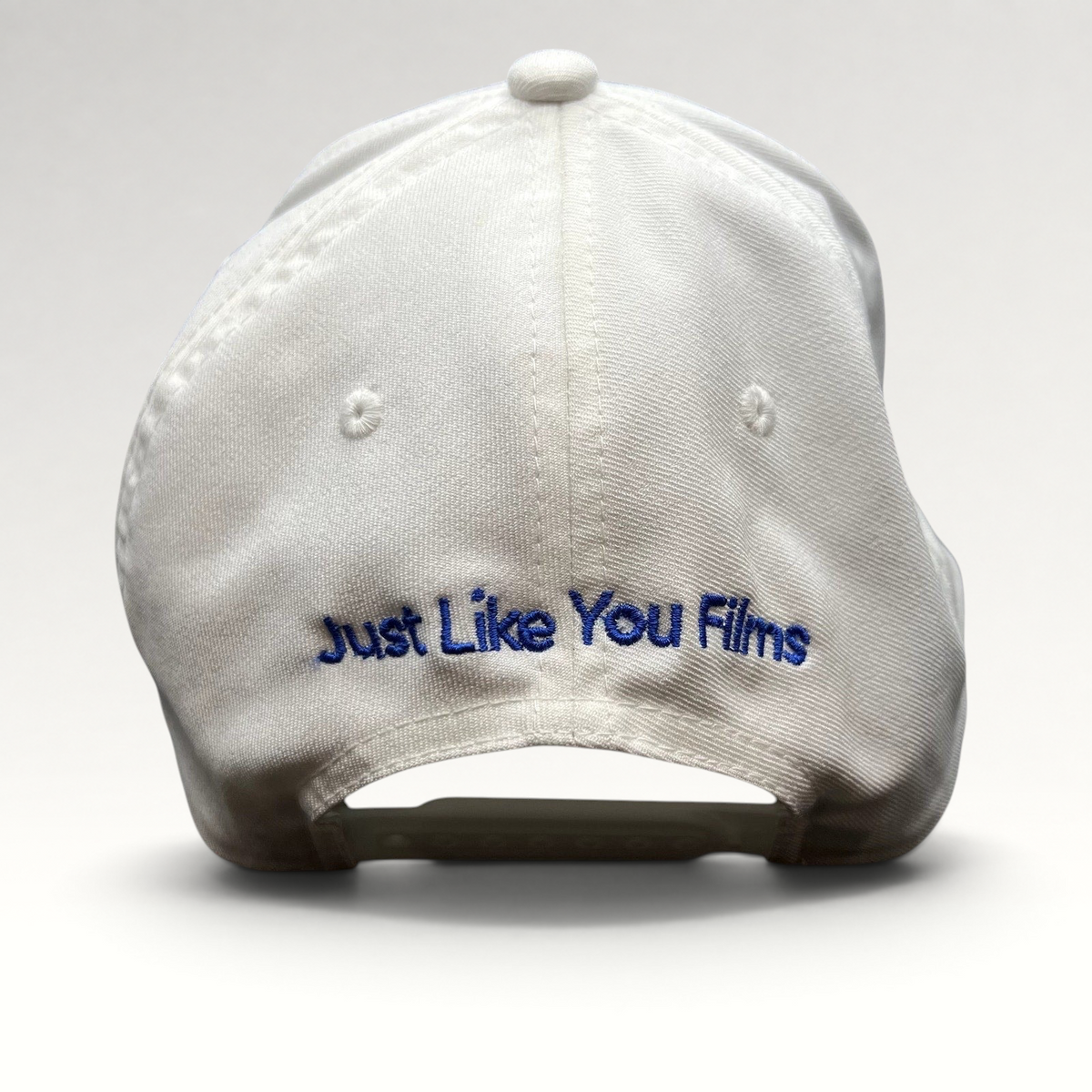 Raree Finds white Flexfit NU snapback hat with Just Like You Films embroidered in royal blue on the back