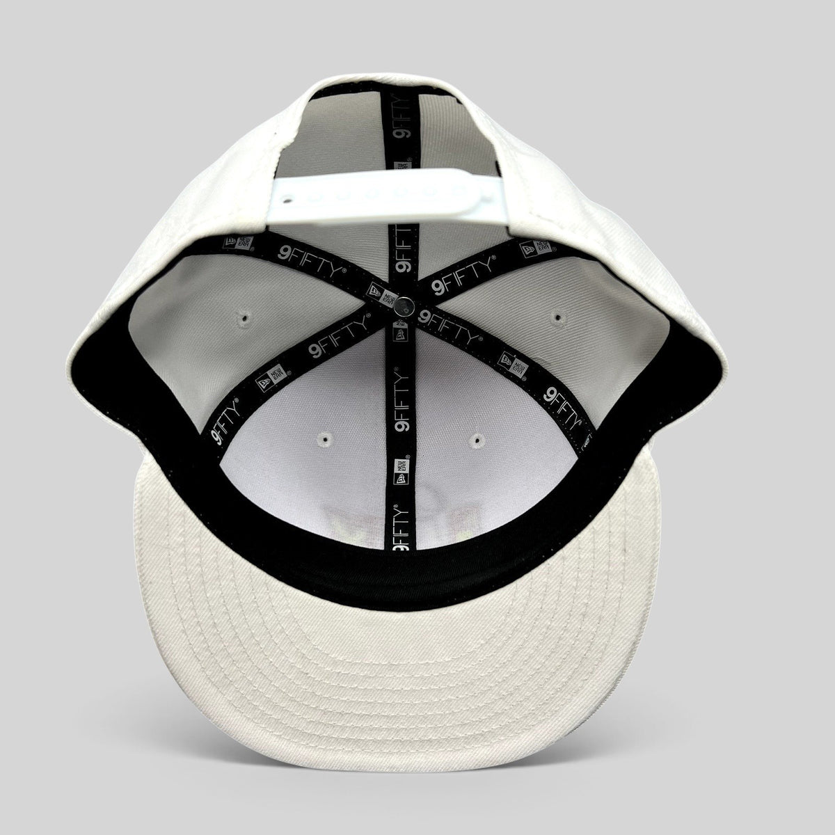 Raree Finds New Era Super Bowl LIX white 9FIFTY snapback hat interior view showing branded taping and adjustable strap