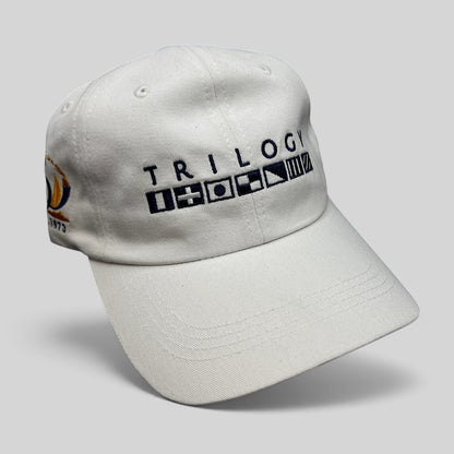Raree Finds white cotton strapback cap featuring Trilogy branding and embroidered nautical signal flags