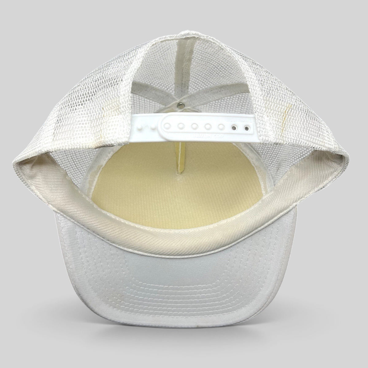 Raree Finds white Y2K Rockstar Energy Drink trucker hat with mesh back and snapback closure, back view