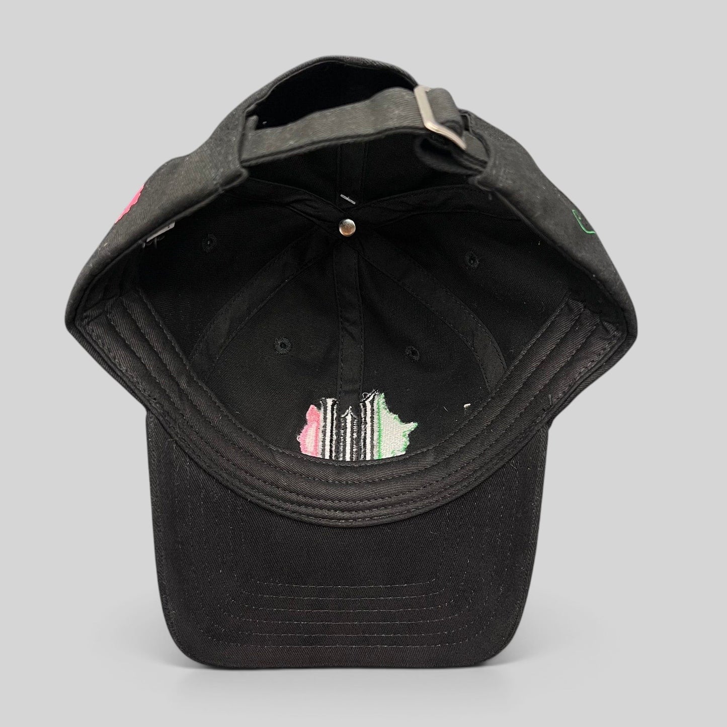 Raree Finds Wicked Broadway musical black cotton strapback hat with green and pink interior embroidery detail