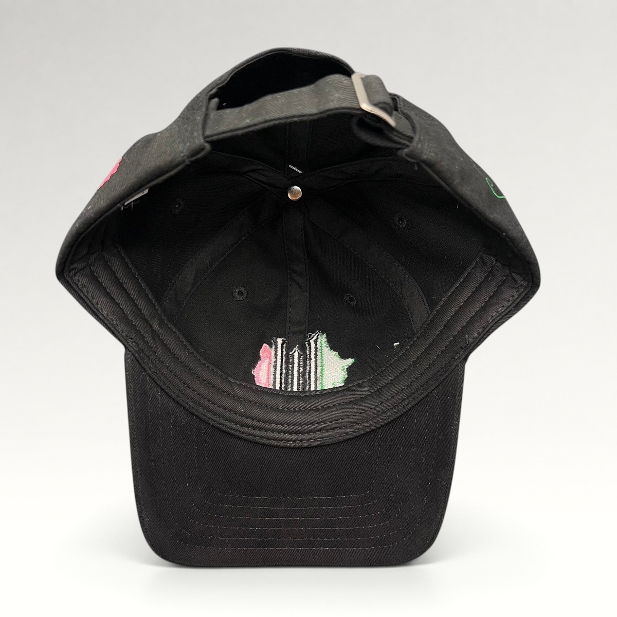 Raree Finds Wicked Broadway musical black cotton strapback hat with green and pink interior embroidery detail