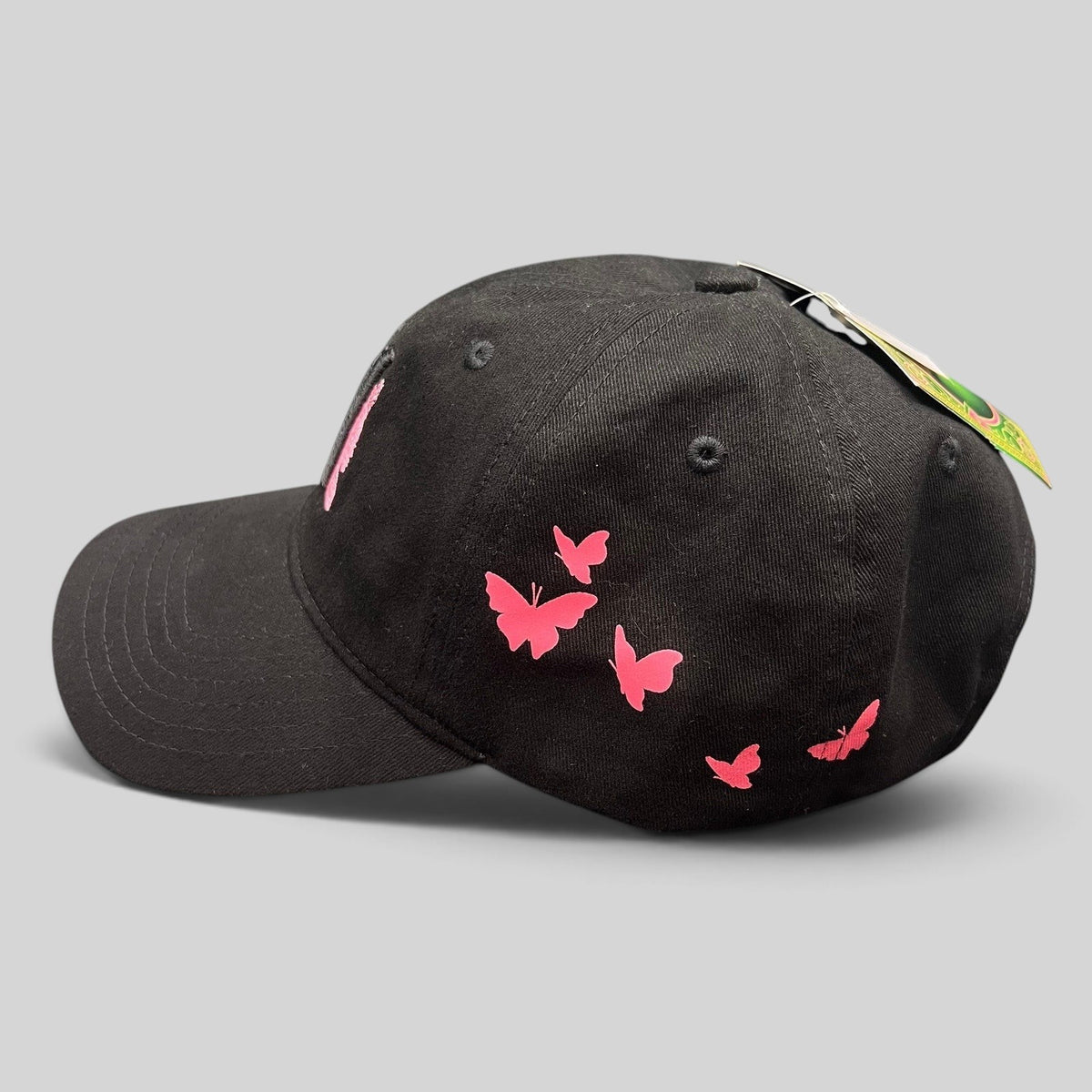Raree Finds black cotton Wicked musical cap with pink butterfly embroidery on the side panel and curved brim