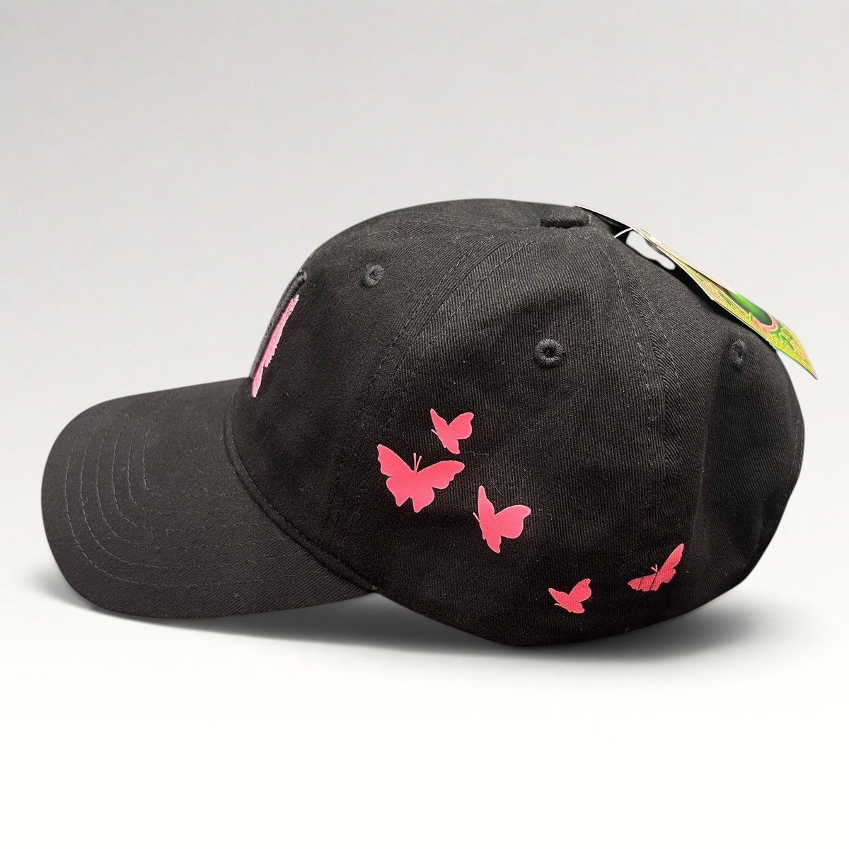 Raree Finds black cotton Wicked musical cap with pink butterfly embroidery on the side panel and curved brim