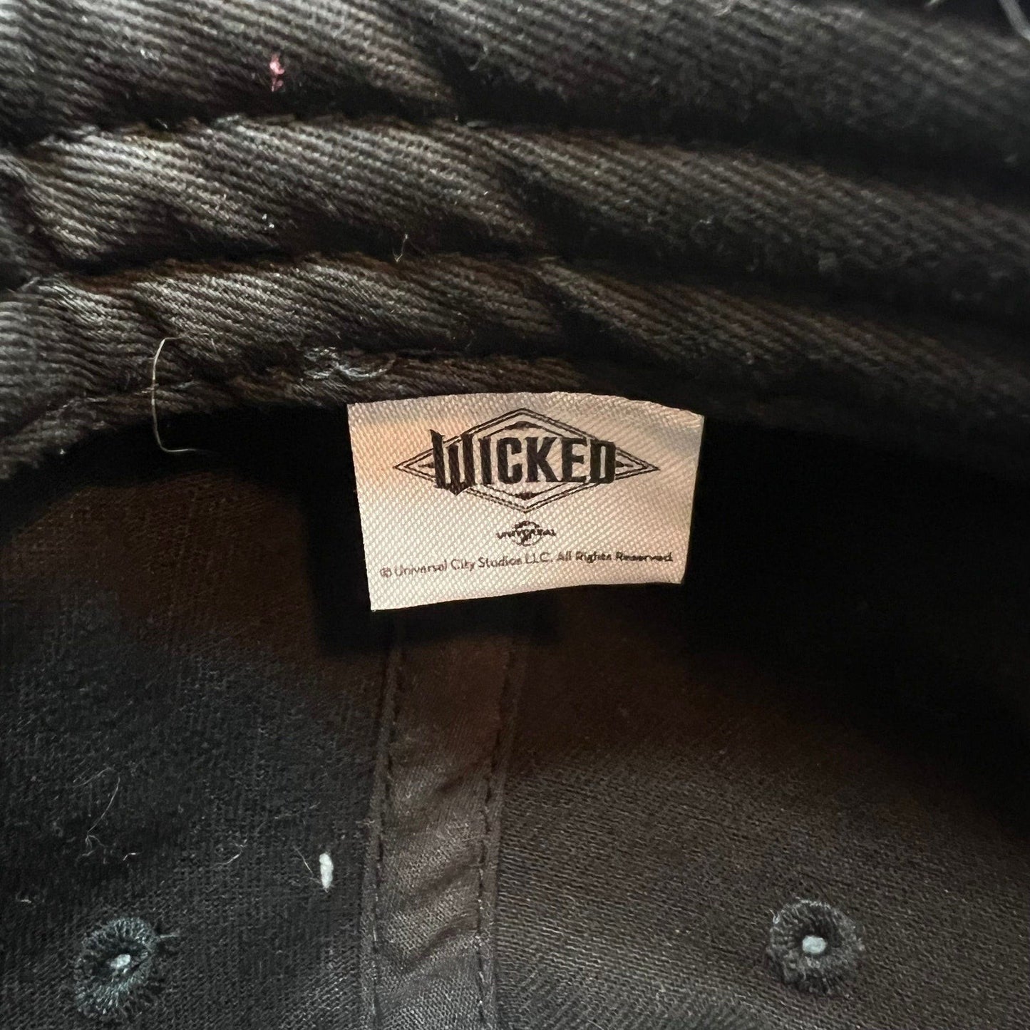 Raree Finds Wicked Broadway musical black cotton hat interior tag with official Universal City Studios branding