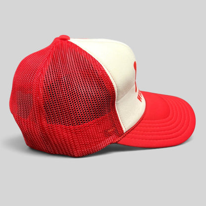 Raree Finds vintage Wienerschnitzel red and white foam trucker hat with mesh back and curved brim side view