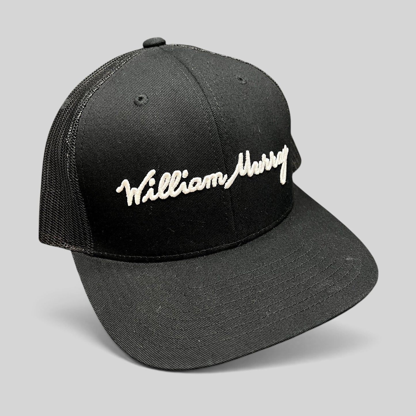Raree Finds black William Murray Golf trucker hat with white script logo embroidery and structured mesh back