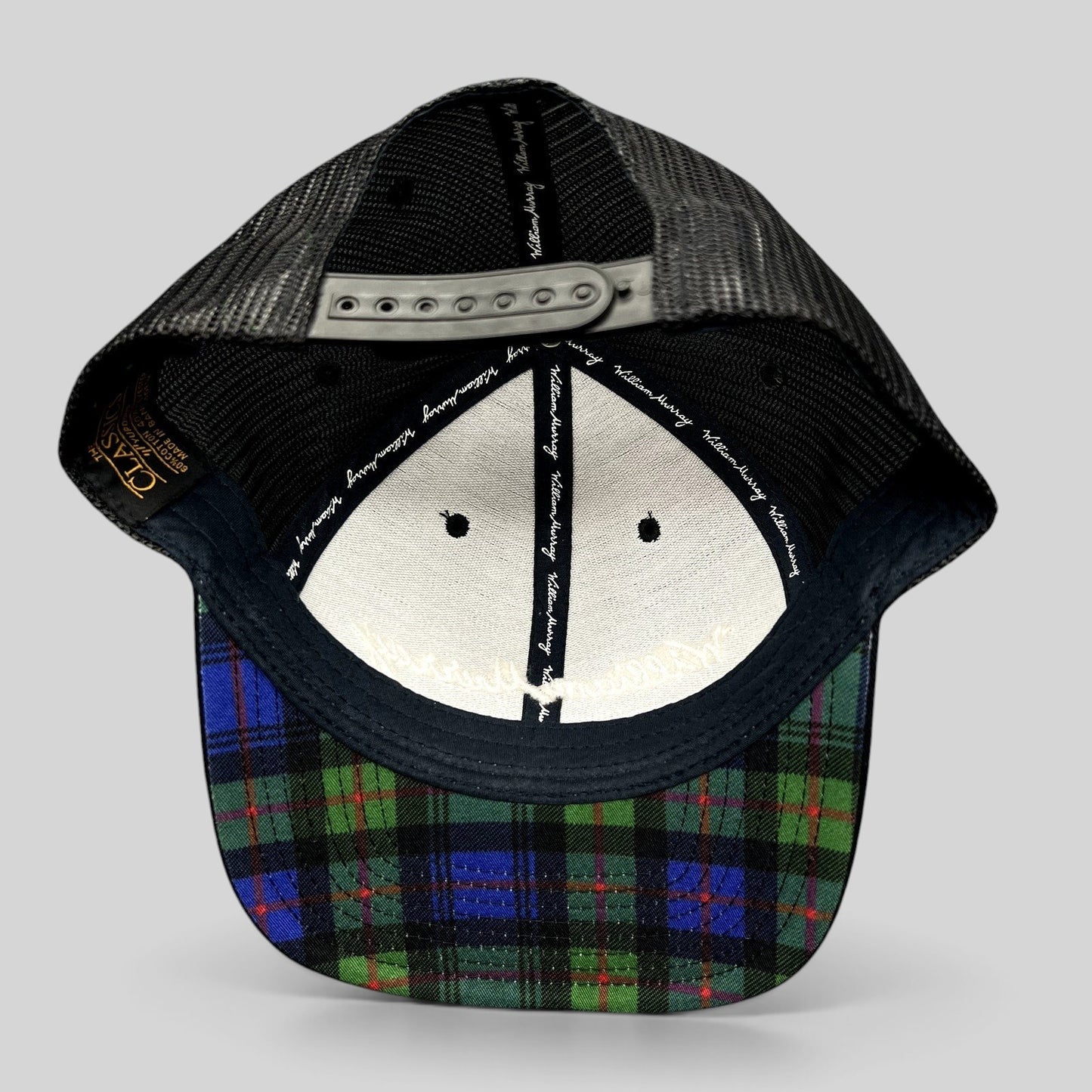 Raree Finds William Murray Golf black trucker hat with mesh back and green and blue tartan plaid undervisor