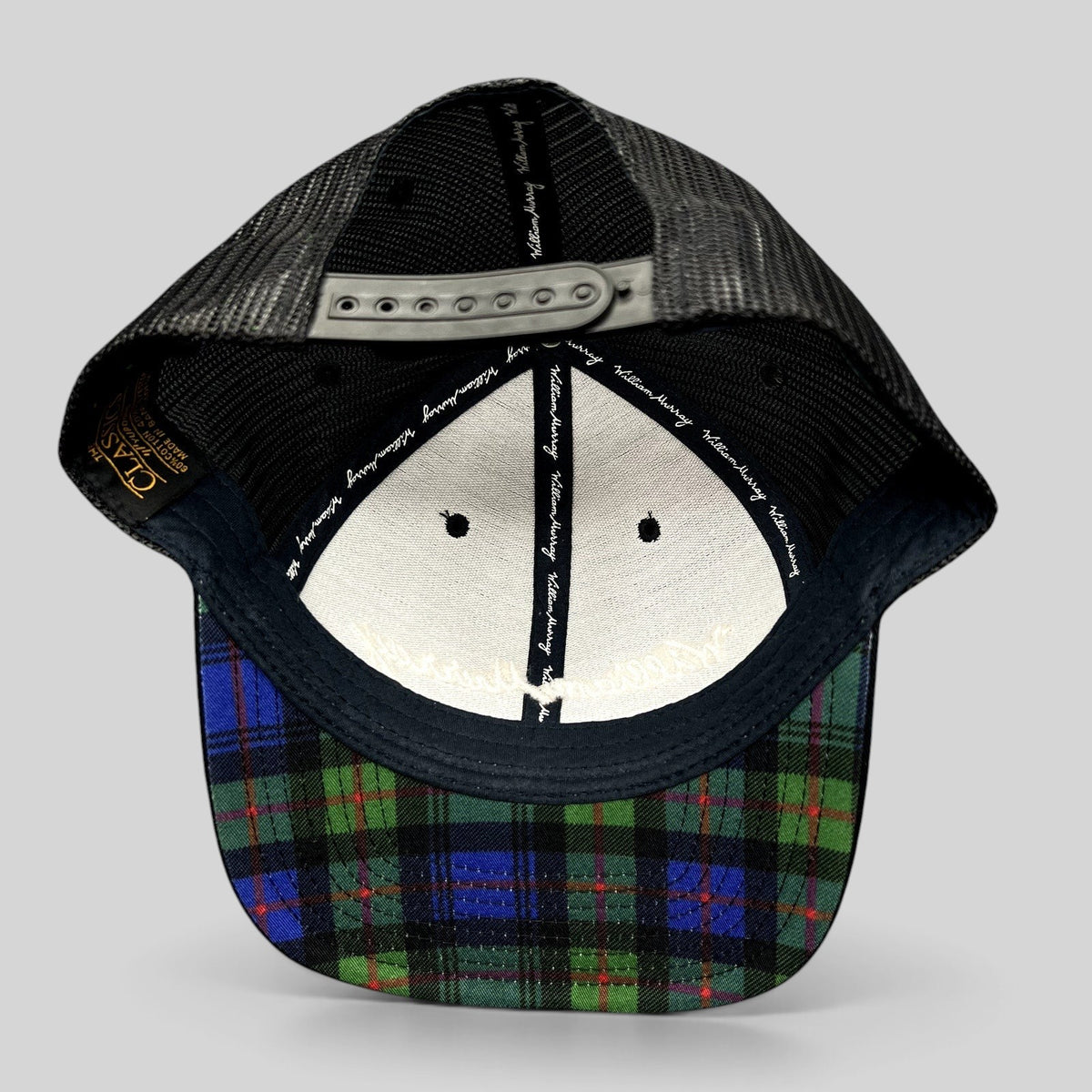 Raree Finds William Murray Golf black trucker hat with mesh back and green and blue tartan plaid undervisor