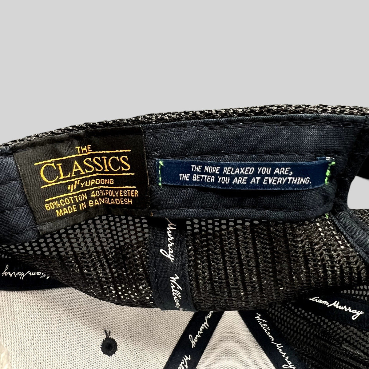 Raree Finds William Murray Golf trucker hat interior showing Yupoong Classics label and inspirational quote tag